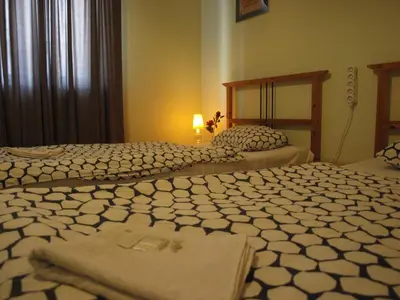 two beds sitting next to each other in a bedroom at Apartmány Rossa in Louny