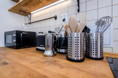 a kitchen counter with several utensils in metal containers at APT in Prague Charles Bridge 1km by Michal&Friends in Prague