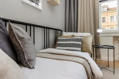 a bedroom with two beds with pillows and a window at APT in Prague Charles Bridge 1km by Michal&Friends in Prague