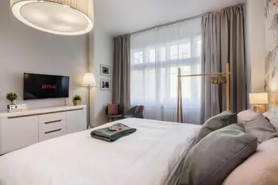 a bedroom with a bed and a tv and a window at APT in Prague Charles Bridge 1km by Michal&Friends in Prague