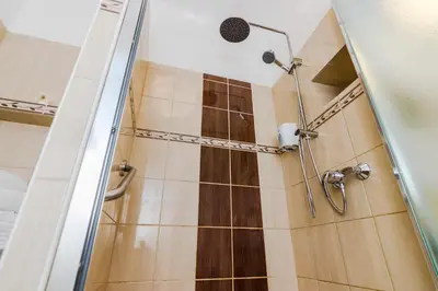 a shower with a glass door in a bathroom at APT in Prague Charles Bridge 1km by Michal&Friends in Prague