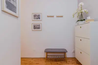 a room with a chair and a white refrigerator at APT in Prague Charles Bridge 1km by Michal&Friends in Prague