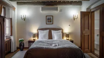 a bedroom with a large bed with two night stands at Aurus by Adrez in Prague