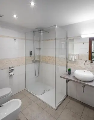 a bathroom with a shower and a toilet and a sink at Aurus by Adrez in Prague