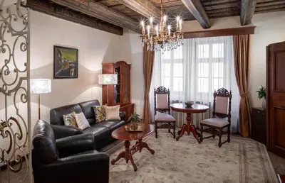 a living room with a couch and a table at Aurus by Adrez in Prague