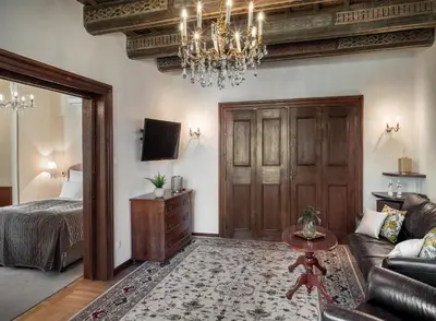 a living room with a bed and a chandelier at Aurus by Adrez in Prague