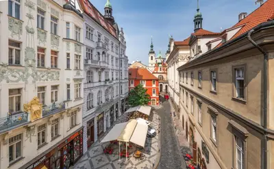 a view of an alley between buildings at Aurus by Adrez in Prague