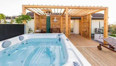 a hot tub on the deck of a house at Romantic studio with jacuzzi in Prague
