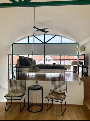 a living room with two chairs and a bed at Romantic studio with jacuzzi in Prague