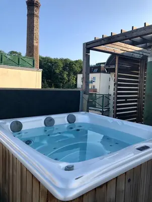 a jacuzzi tub sitting on top of a roof at Romantic studio with jacuzzi in Prague