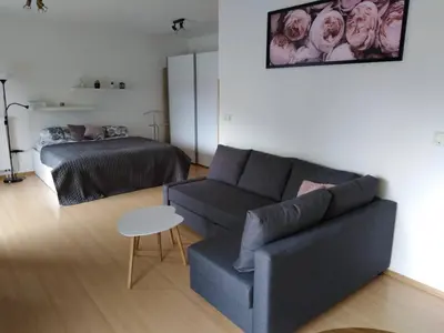 a living room with a couch and a bed at Apartment Archa Poděbrady in Poděbrady