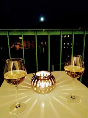 two glasses of wine sitting on a table with a bowl at Apartment Archa Poděbrady in Poděbrady