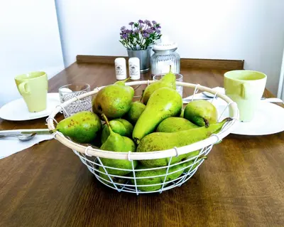 a basket of pears on a wooden table at Apartment Archa Poděbrady in Poděbrady