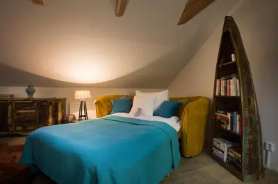 a bedroom with a bed and a book shelf at Gigantic Boho Chic 3 Bedroom 3 Bathroom Loft with Hanging Chair in Prague
