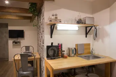 a kitchen with a sink and a wooden table at Gigantic Boho Chic 3 Bedroom 3 Bathroom Loft with Hanging Chair in Prague