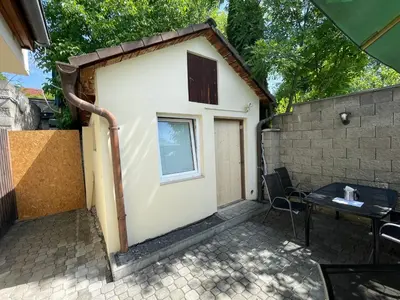 a small house with a table and a window at Penzion Nová Hospoda in Prague