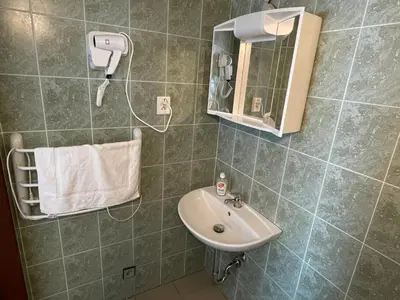 a bathroom with a sink and a mirror at Penzion Nová Hospoda in Prague