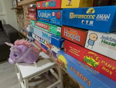 a stack of books with a stuffed animal on a stool at The RoadHouse Prague in Prague