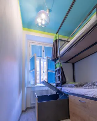 a bedroom with a bunk bed and a window at The RoadHouse Prague in Prague