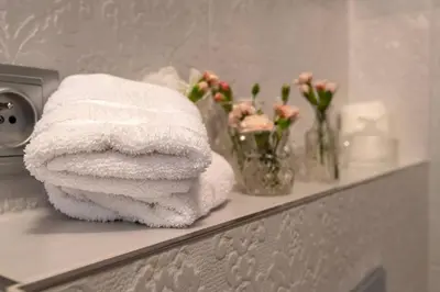 a pile of towels on a shelf in a bathroom at Arch II at Wenceslas in Prague