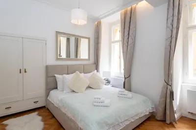 a bedroom with a bed with two towels on it at Arch II at Wenceslas in Prague