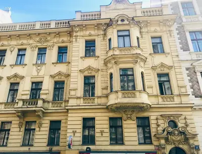 a yellow building with a lot of windows at Arch II at Wenceslas in Prague