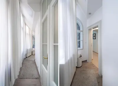 a hallway with white walls and white doors at Quiet apartment in the heart of Old Town centre in Prague