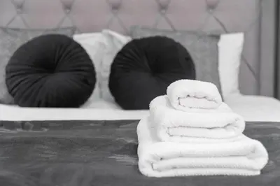 a pile of towels sitting on top of a bed at Quiet apartment in the heart of Old Town centre in Prague