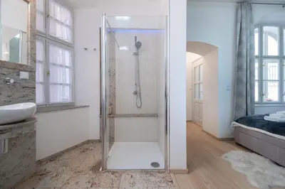 a bathroom with a shower with a glass door at Quiet apartment in the heart of Old Town centre in Prague