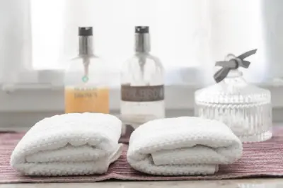 two towels sitting on a table with bottles of alcohol at Quiet apartment in the heart of Old Town centre in Prague