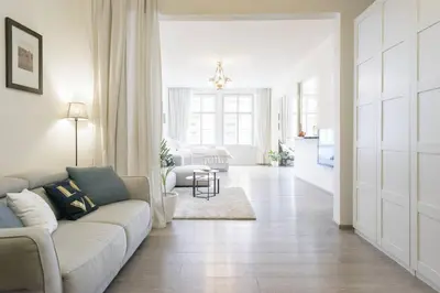 a white living room with a couch and a living room at Stylish, Light-Filled Home in the Historic Center in Prague