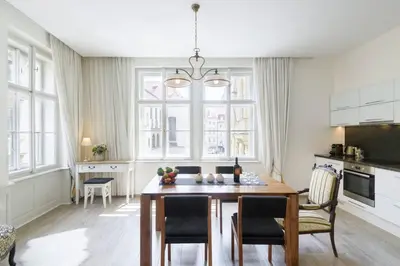 a kitchen and dining room with a table and chairs at Stylish, Light-Filled Home in the Historic Center in Prague
