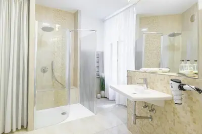a bathroom with a shower and a sink at Stylish, Light-Filled Home in the Historic Center in Prague