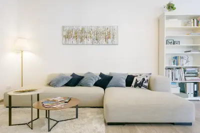 a white living room with a couch and a table at Stylish, Light-Filled Home in the Historic Center in Prague