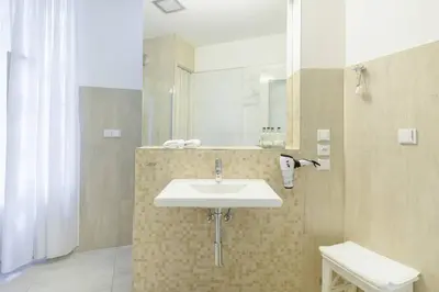 a bathroom with a sink and a mirror at Stylish, Light-Filled Home in the Historic Center in Prague