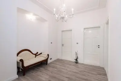 a living room with a chair and a chandelier at Wenceslas Square / Main Station - NEW STUDIO***** in Prague