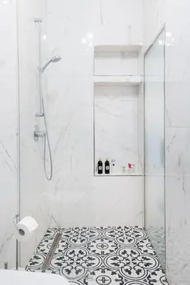 a bathroom with a shower and a black and white floor at Wenceslas Square / Main Station - NEW STUDIO***** in Prague