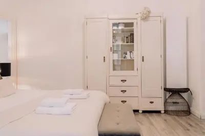 a white bedroom with a white cabinet and towels at Wenceslas Square / Main Station - NEW STUDIO***** in Prague