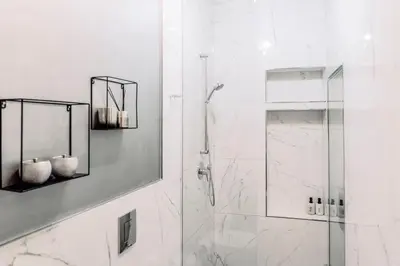 a bathroom with a shower with a glass door at Wenceslas Square / Main Station - NEW STUDIO***** in Prague