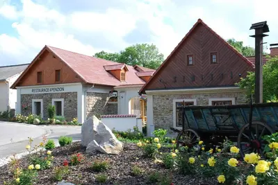 a house with a wagon in front of it at Penzion Ve stoleti in Loděnice