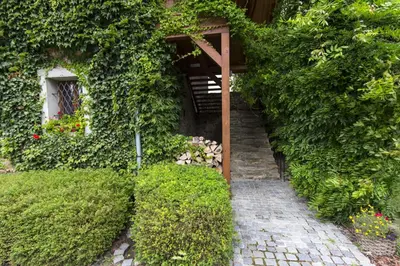 a garden with a stairway leading up to a building at Penzion Ve stoleti in Loděnice