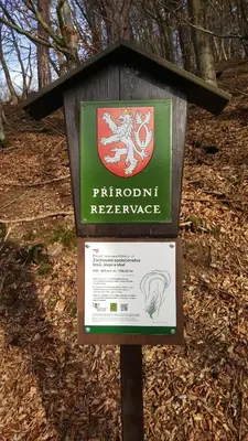 a sign for a rhino refuge in the woods at Penzion a Restaurace Nad Hradem in Křivoklát