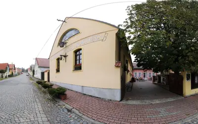 a building on the side of a street at Penzion a Restaurace Nad Hradem in Křivoklát