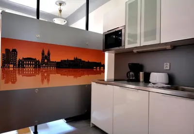 a kitchen with a city skyline mural on the wall at Historic Centre Apartments VIII in Prague