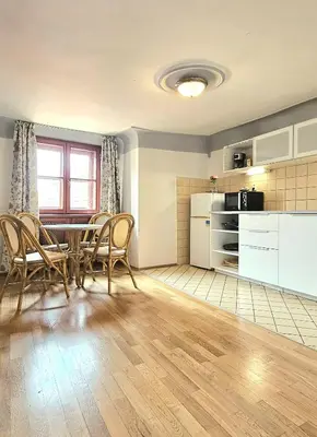 a kitchen and dining room with a table and chairs at Historic Centre Apartments VIII in Prague