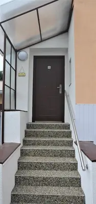 a set of stairs leading to a door in a building at Apartmány Pod vodárenskou věží in Poděbrady