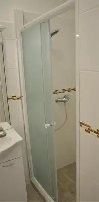 a bathroom with a shower with a glass door at Apartmány Pod vodárenskou věží in Poděbrady