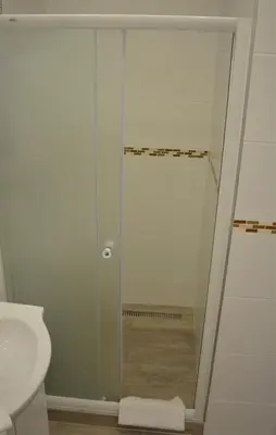 a glass shower in a bathroom with a toilet at Apartmány Pod vodárenskou věží in Poděbrady
