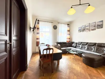 a living room with a table and a couch at Spacious cozy apartments in centre in Prague
