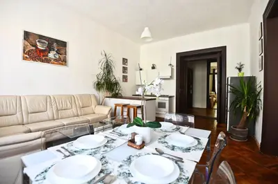 a living room with a table and a couch at Spacious cozy apartments in centre in Prague